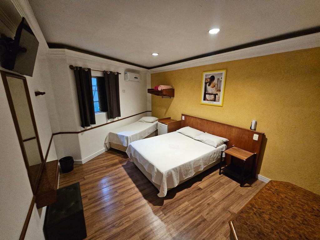 a small room with two beds and a window at Option Hotel São Paulo - Anhembi - Expo Center Norte in São Paulo