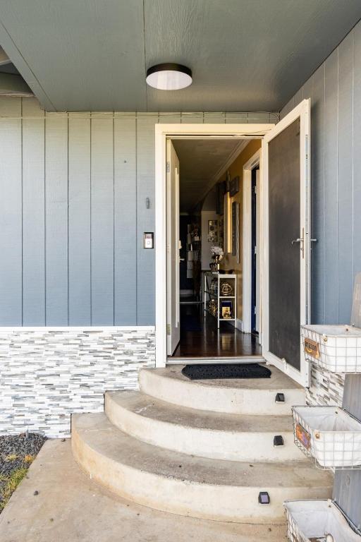 a hallway of a house with stairs leading to a door at Memorable Moment at Placid Blue with Pool & Hot Tub in Sacramento