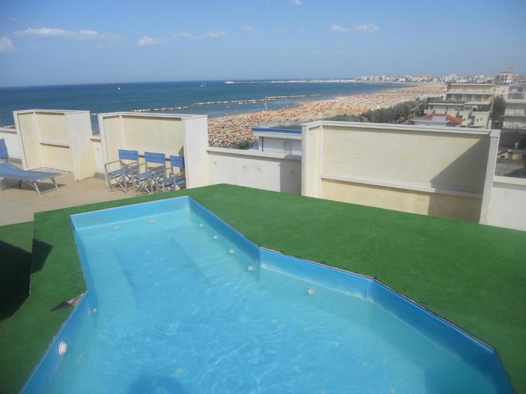 a blue swimming pool on the roof of a house at AmbientHotels Panoramic in Rimini