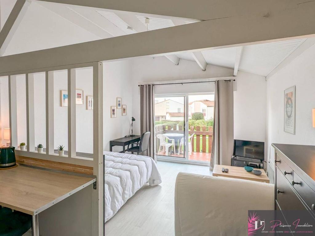 - un salon avec un lit et une télévision dans l'établissement Studio confortable à La Rochelle avec balcon - FR-1-825-68, à La Rochelle