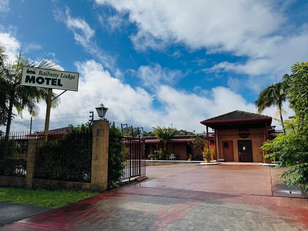 a motel sign in front of a house at Railway Lodge Motel in Taree