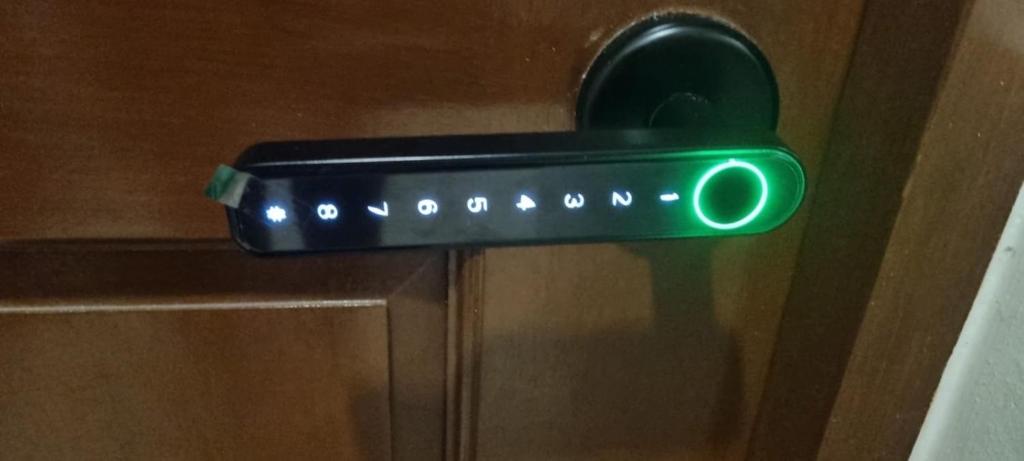 a green door handle with a green light on it at Cozy 1-Br Home-Away-from-Home in Lapu Lapu City