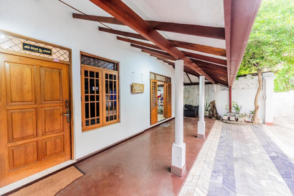 an image of a house with a wooden door at Sun & Sands Villa Wadduwa in Wadduwa