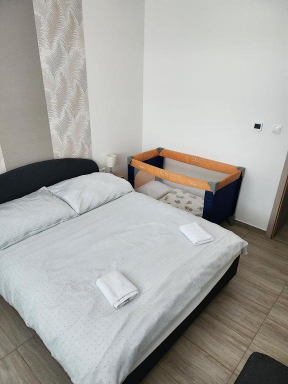 A bed or beds in a room at Apartmány Roland