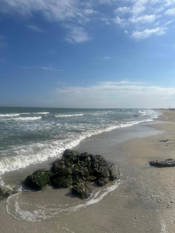 a group of rocks in the sand on a beach at Casa/camere Maria in Corbu