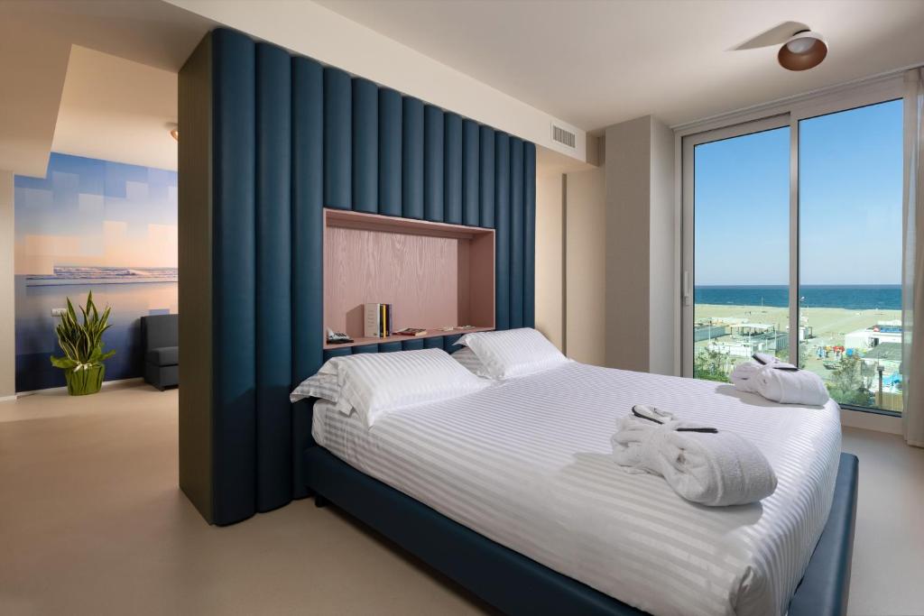 Postel nebo postele na pokoji v ubytování Mercure Hotel Rimini Artis