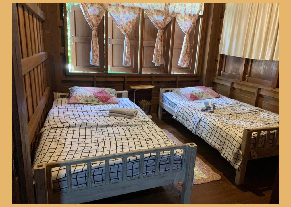 Postel nebo postele na pokoji v ubytování Yor Song Hostel