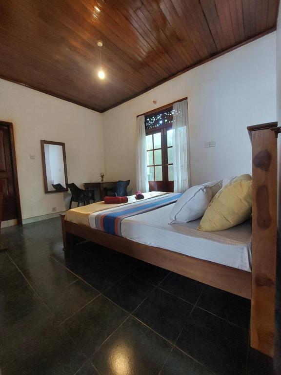 a bedroom with a large bed in a room at Mystique Hideout in Kandy