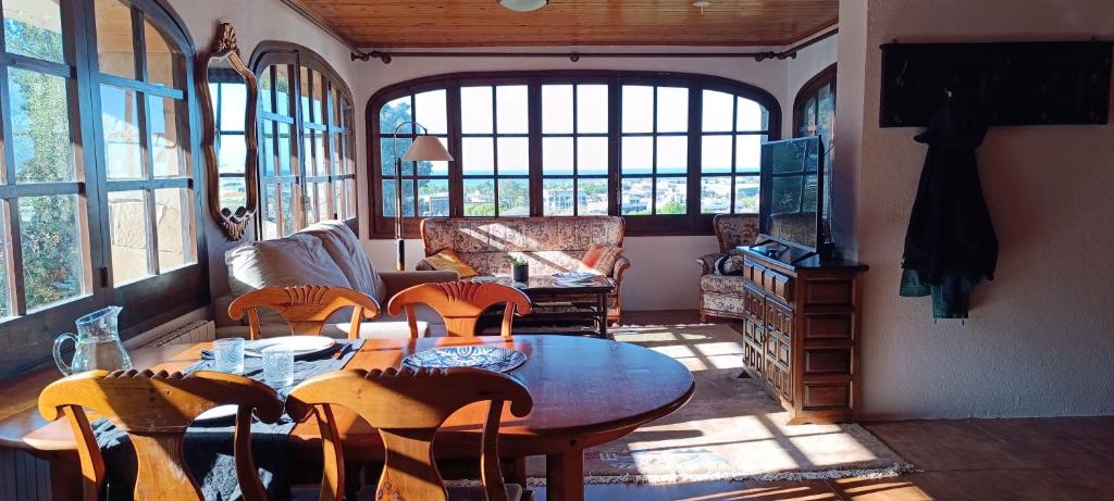 a living room with a table and chairs at cave house with sea views in Santa Susanna