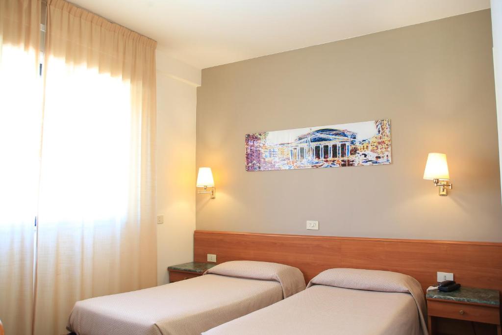 Postel nebo postele na pokoji v ubytování Hotel Sisto V