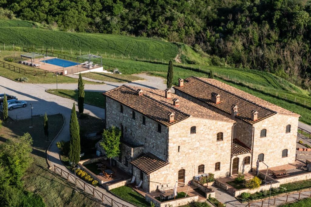 an aerial view of a stone house with a pool at Podere Fossaccio Casa Biancospino in Asciano