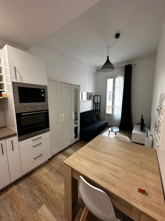 une cuisine et un salon avec une table et un canapé dans l'établissement Studio - port de Nice - balcon, à Nice
