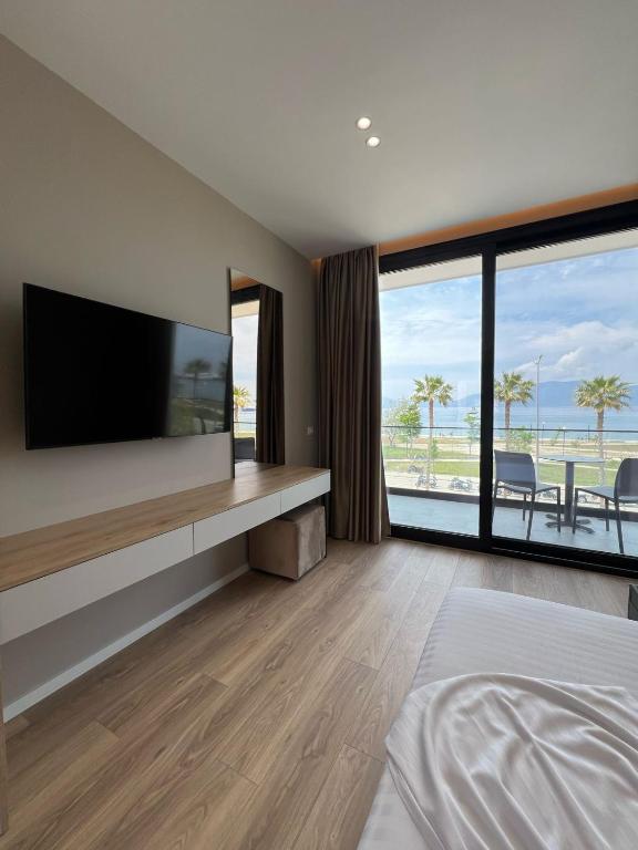 a bedroom with a flat screen tv on a wall at Villa Blu in Vlorë
