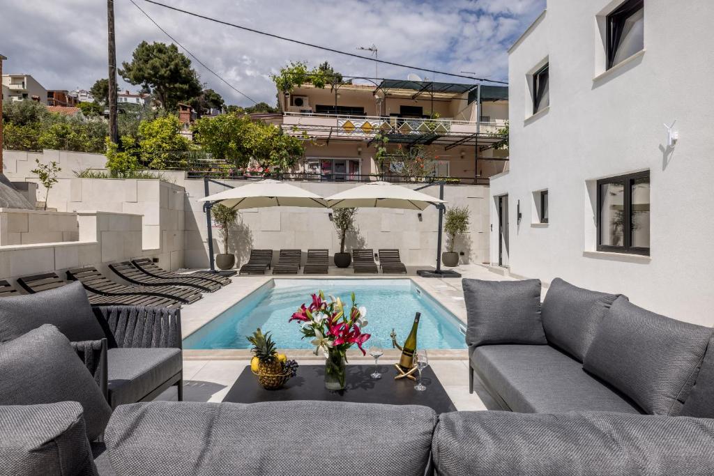 a living room with a couch and a swimming pool at Villa Lavea in Trogir