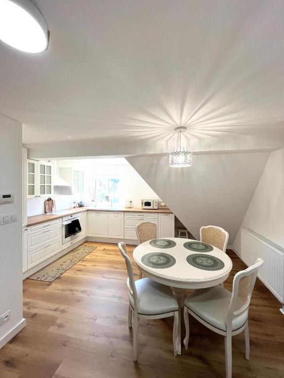 a kitchen with a table and chairs in a room at Pod 20 in Jelenia Góra
