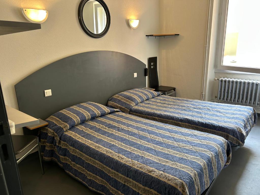Ένα ή περισσότερα κρεβάτια σε δωμάτιο στο CHAMBRE TWIN PROCHE de LA GARE