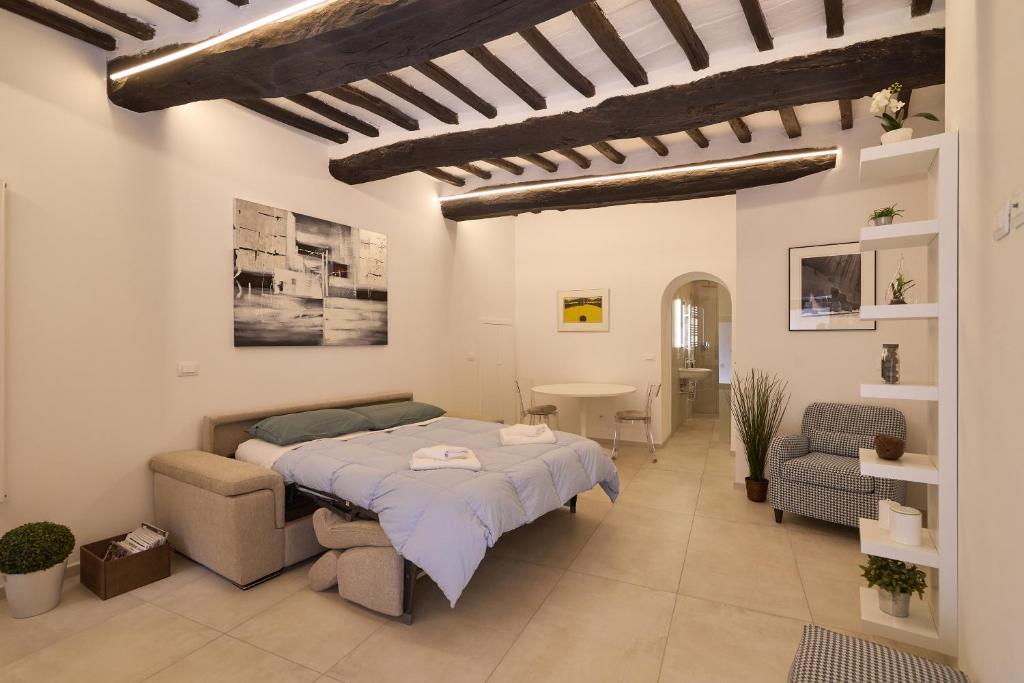 a bedroom with a bed and a table and chairs at Suite n12 - Loft incantevole nel cuore di Perugia in Perugia