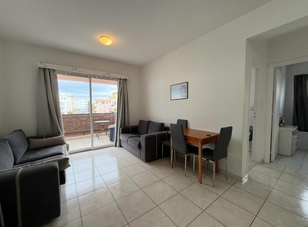a living room with a table and a couch at Central 2 Bedroom Apartment Pafia 2 in Paphos City