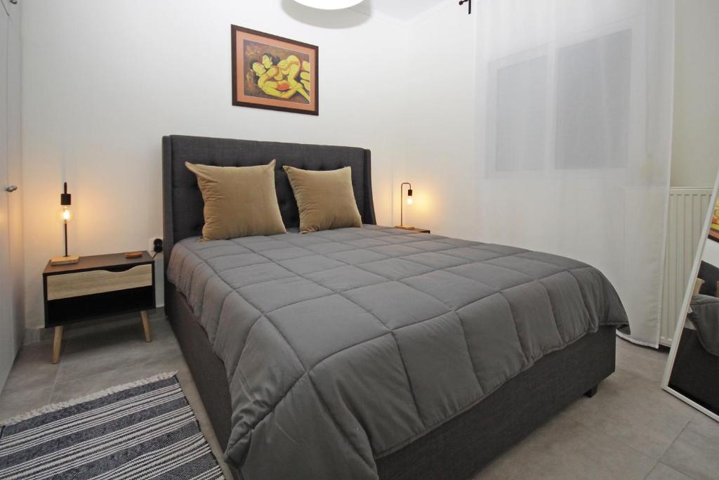 a bedroom with a bed and a side table at Luxury apartment in sithonia in Neos Marmaras