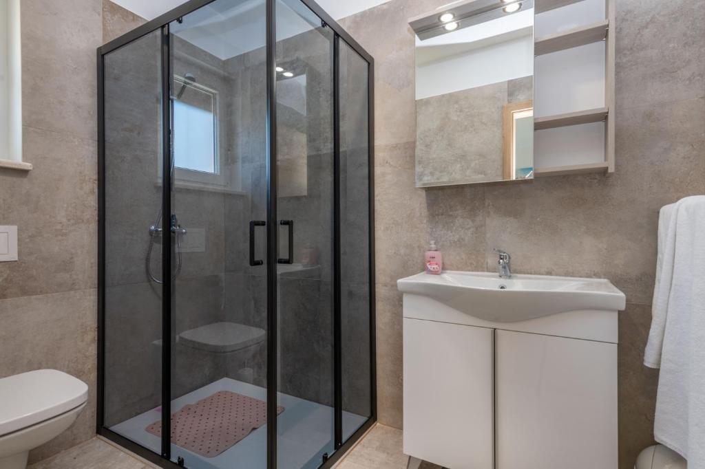 a bathroom with a shower and a sink at Villa Maria, a charming villa near Labin in Nedeščina
