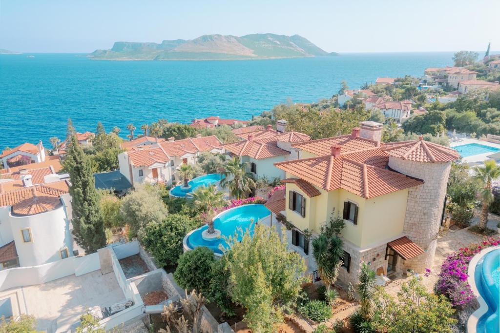 an aerial view of a villa with a resort and the ocean at Villa Limon, Cukurbag Peninsula-Kas in Kaş