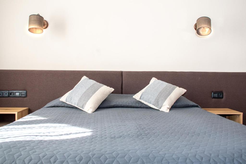 Postel nebo postele na pokoji v ubytování Hotel Orphey
