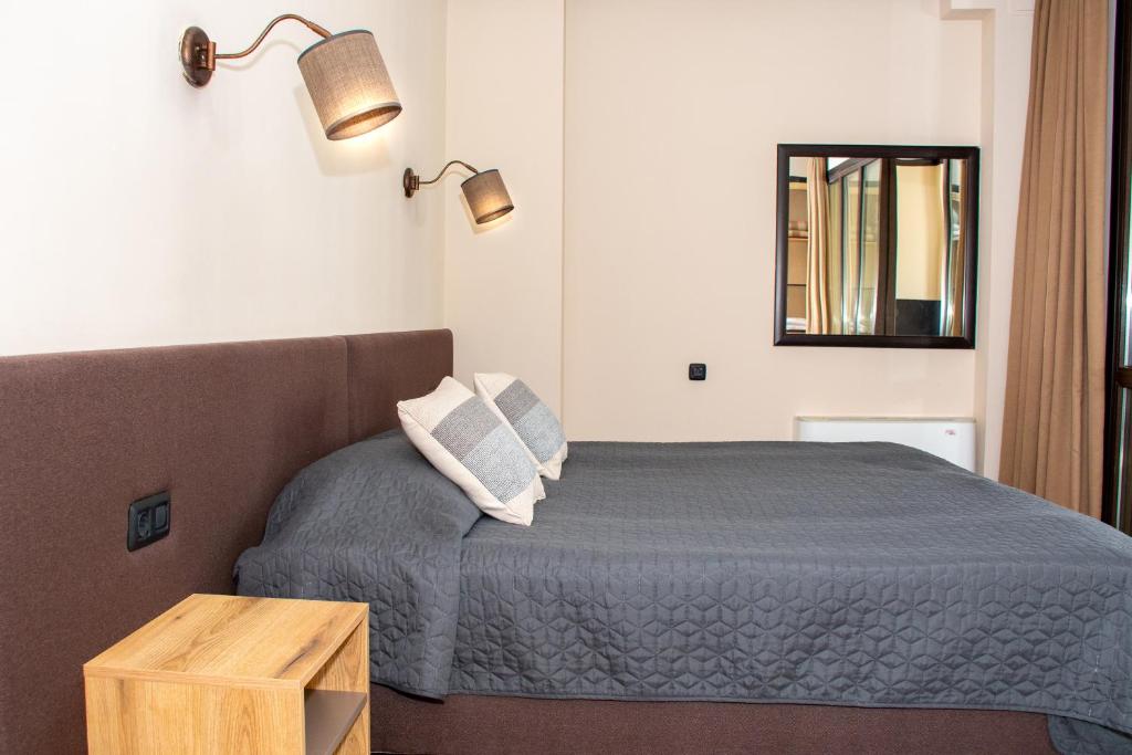 Postel nebo postele na pokoji v ubytování Hotel Orphey