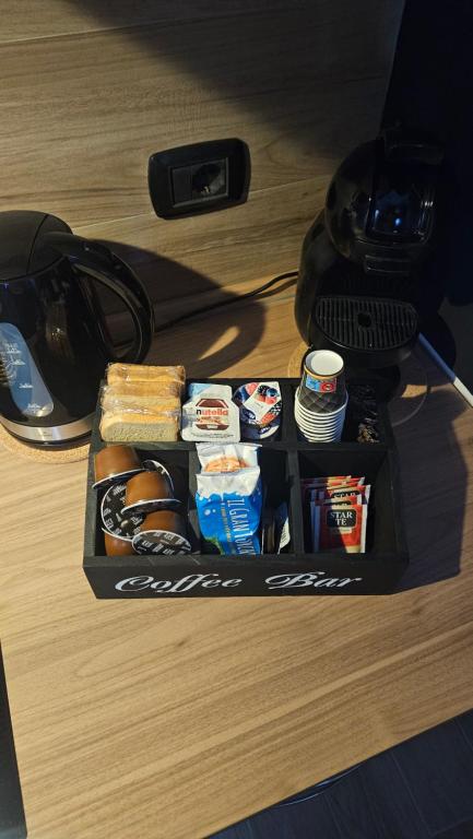 a lunch box with food and drinks on a desk at LORY ROOM vacation home in Quartu SantʼElena