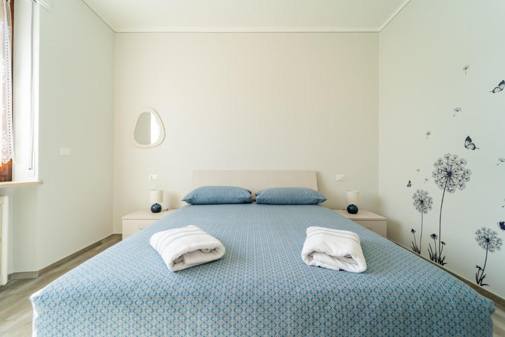 Кровать или кровати в номере Elegante Appartamento con Terrazzo - Parcheggio Gratuito Privato & Wifi