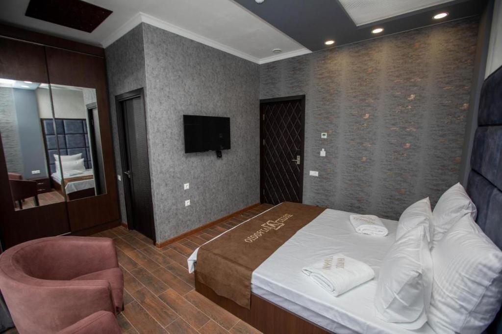 Postel nebo postele na pokoji v ubytování WIAGGIO Hotel