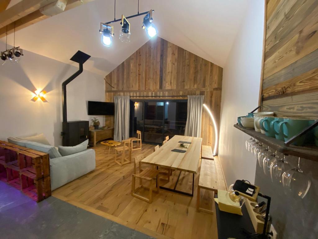 a living room with a table and a couch at Chalet du Trappeur in Les Orres