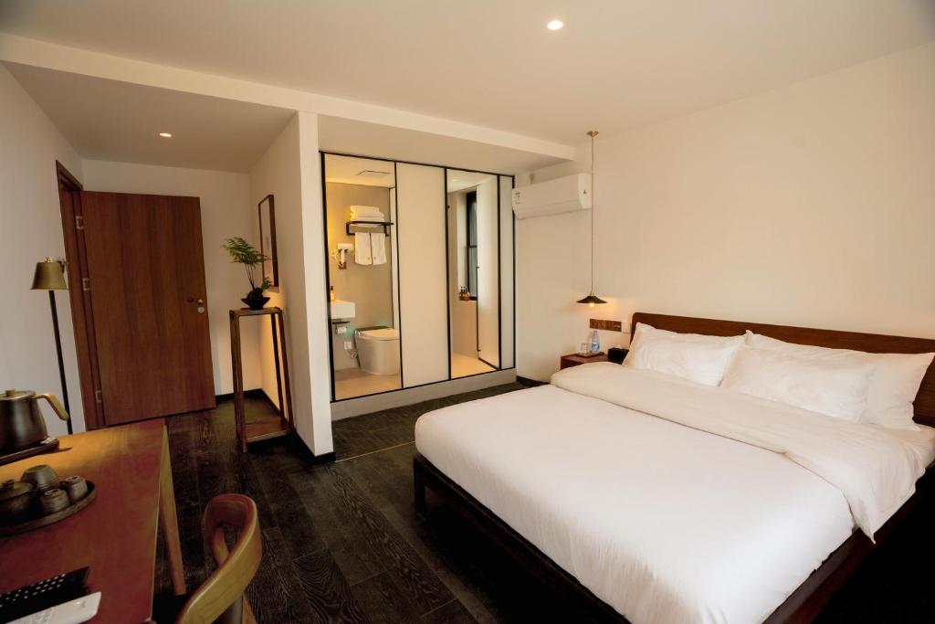 Postel nebo postele na pokoji v ubytování Xingle Hotel-Suzhou Guanqian Street Pingjiang Road