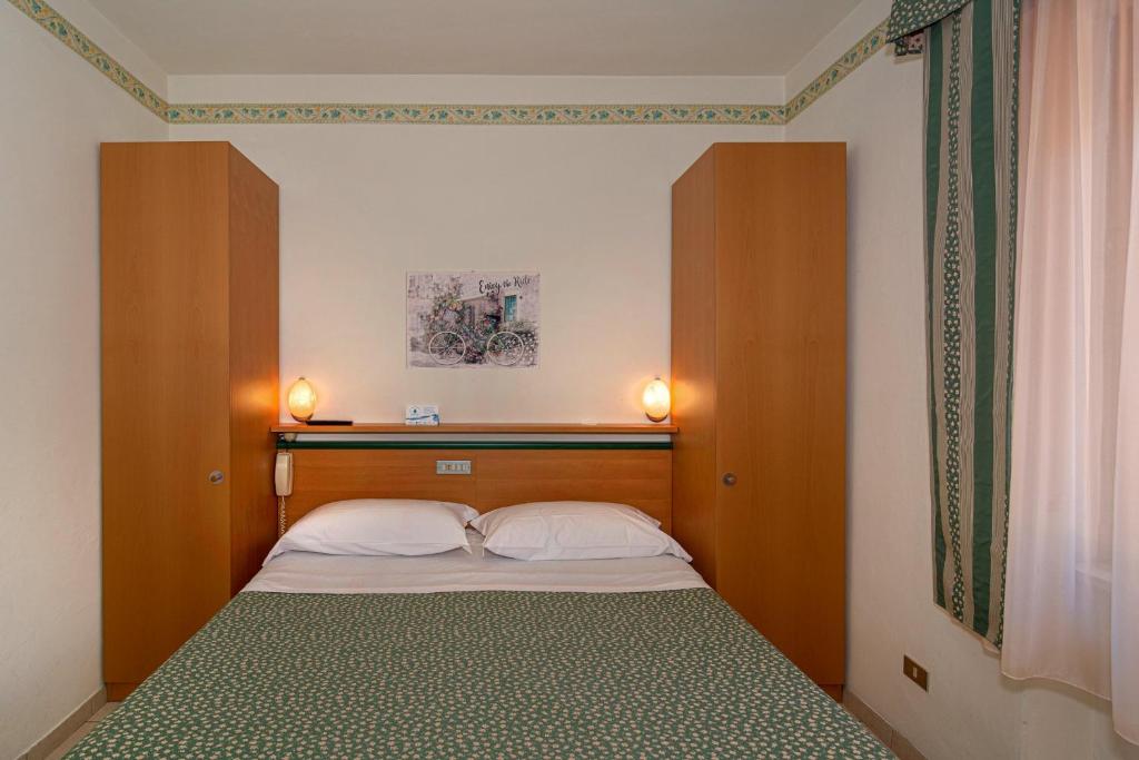 Postel nebo postele na pokoji v ubytování Hotel Mariani