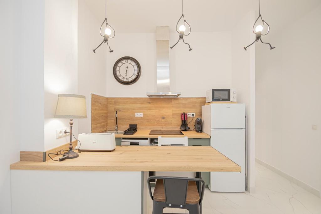 a kitchen with a wooden counter and a refrigerator at NEW! Stunning modern 2BR apt next to Feria in Seville