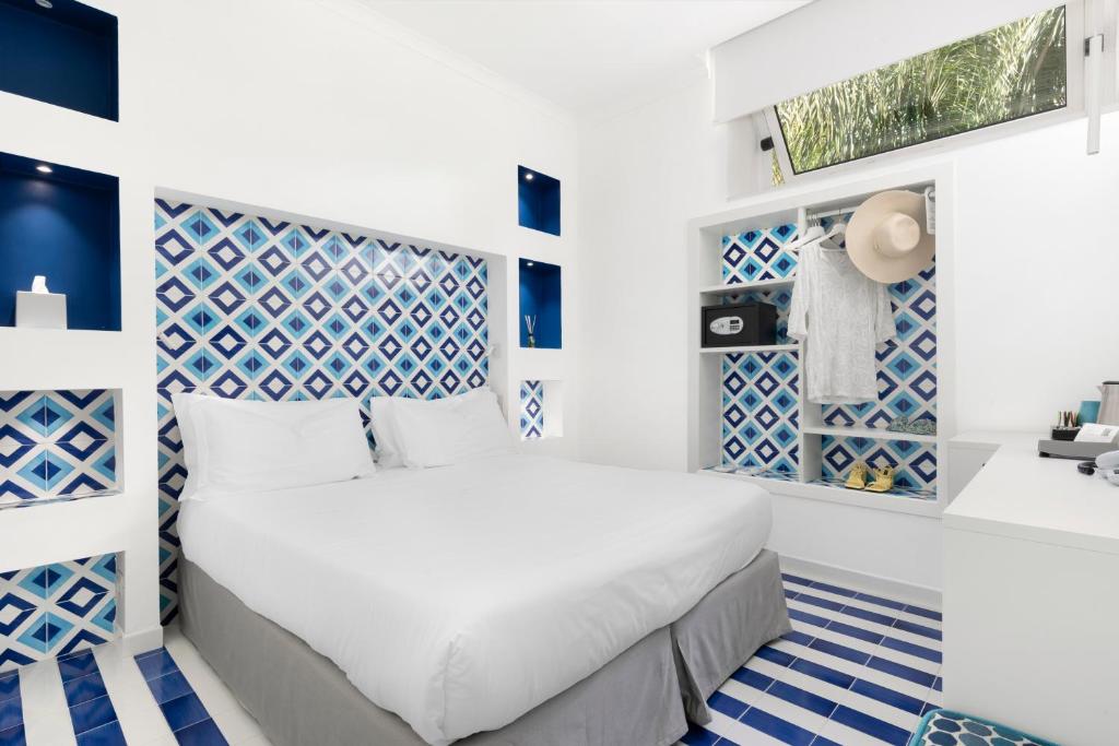 Postel nebo postele na pokoji v ubytování Hotel Bougainville