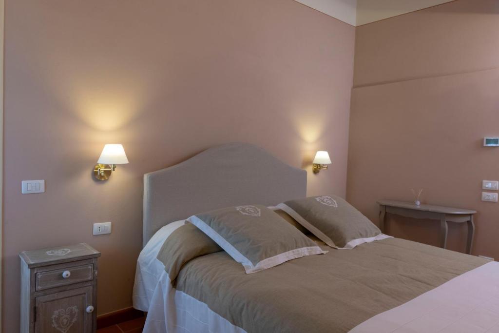 a bedroom with a bed with two pillows on it at Tenuta Piroddi in Fognano