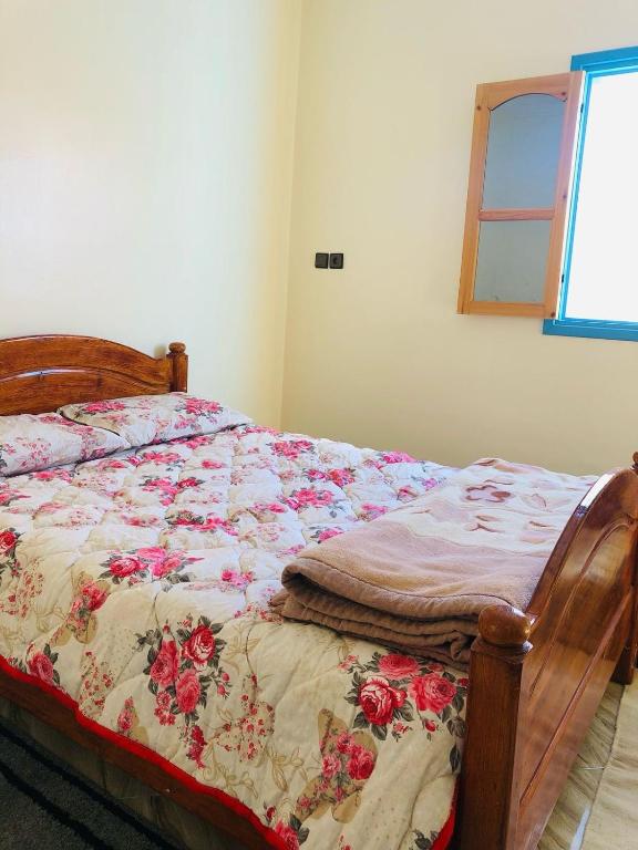 a bedroom with a bed with a quilt on it at Small house merlift in Mirleft