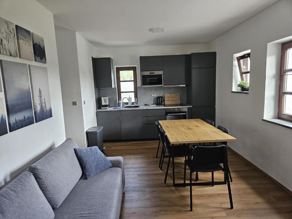 a living room with a couch and a table at Apartmán Maya in Horní Planá