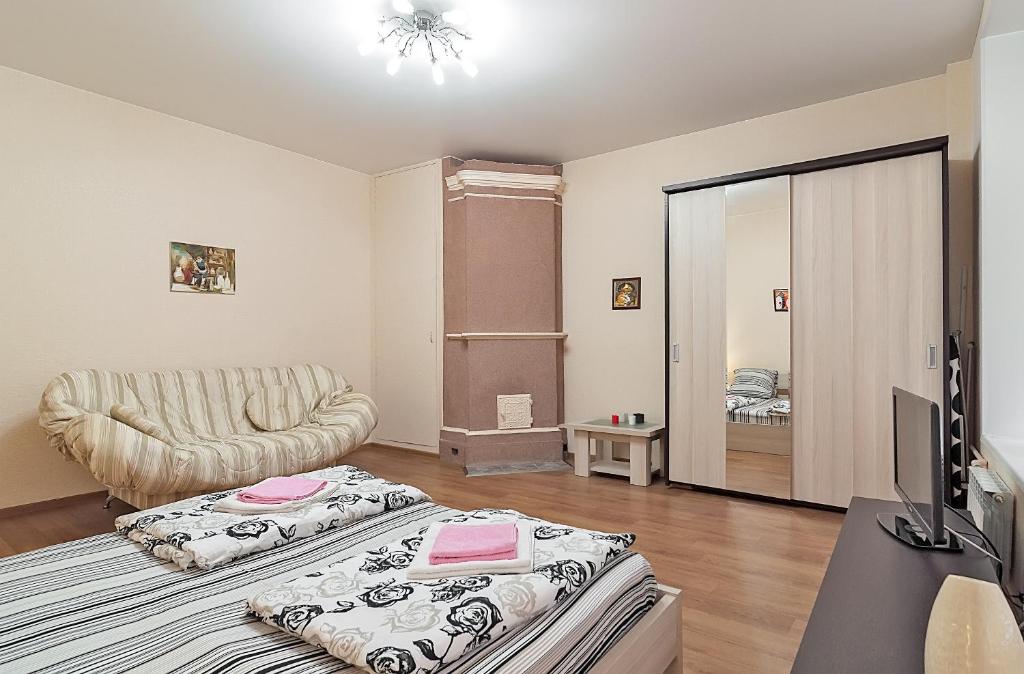 a living room with a bed and a couch at Apartments near Mariinsky Theatre in Saint Petersburg