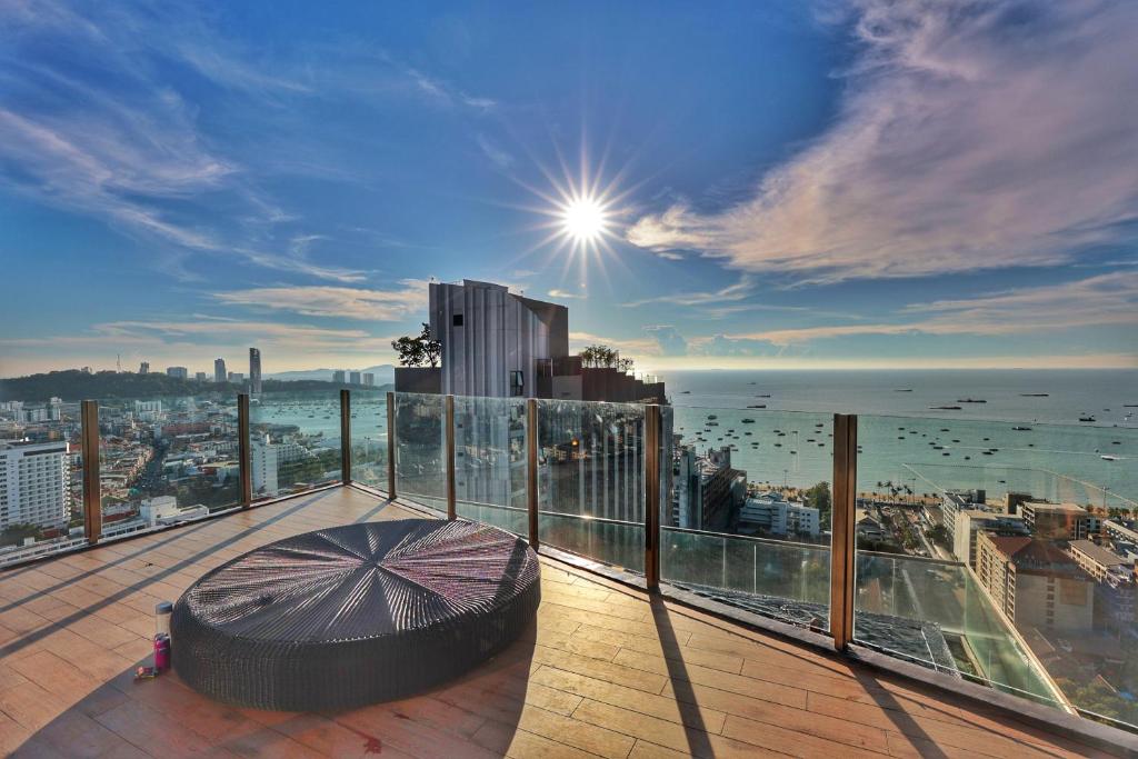 a balcony with an umbrella on top of a building at The base central Pattay CD in Pattaya Central
