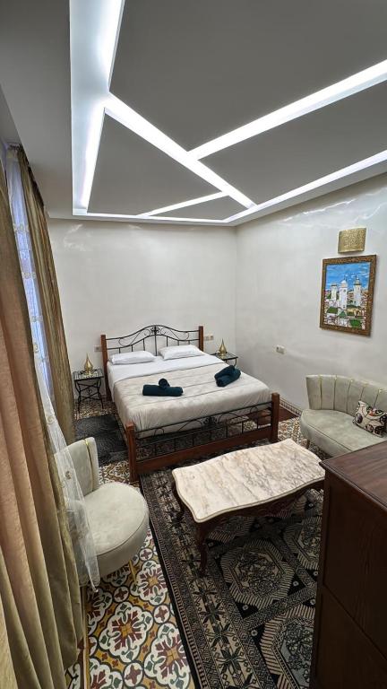 a bedroom with two beds and a skylight at Appartement Dar LALA 1 in Fez