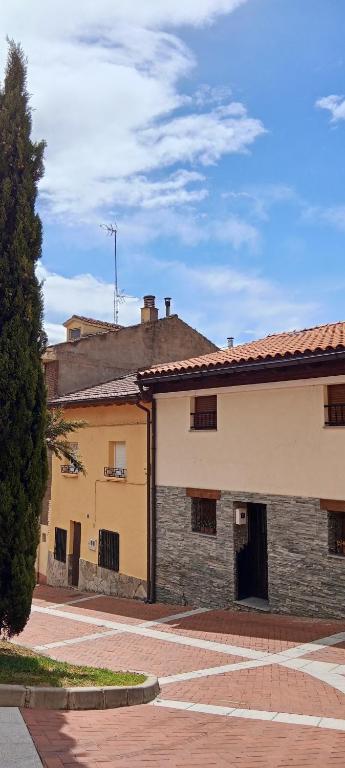 a building with a tree in front of it at Casa TEO in Entrena