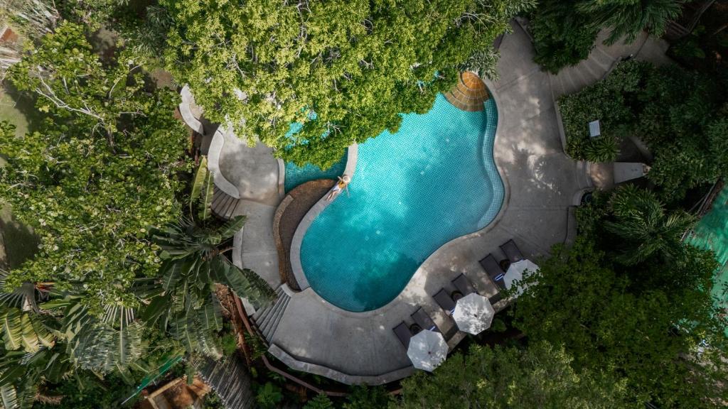 an aerial view of a swimming pool in a resort at Baan Krating Phuket Resort -SHA Plus in Nai Harn Beach