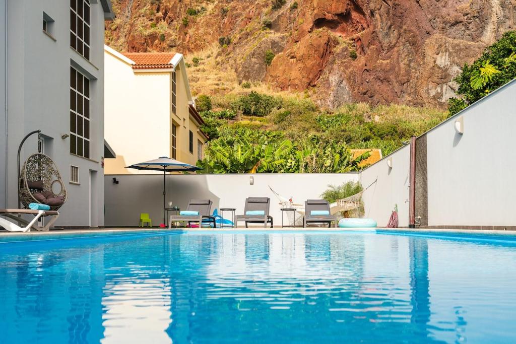 una piscina con una montagna sullo sfondo di Villa Salinas a Paul do Mar