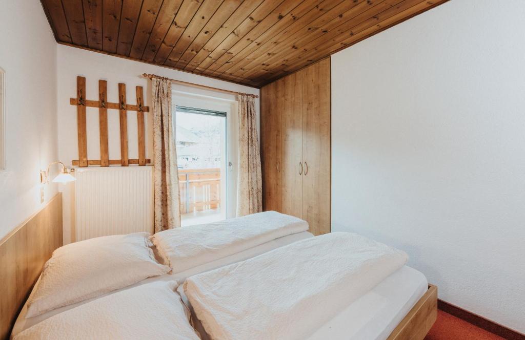 dwa łóżka w pokoju z oknem w obiekcie Unterhauserhof App B w mieście Valdaora