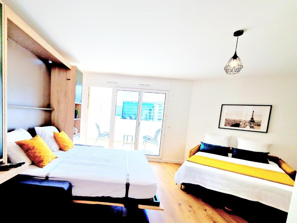 リュエイユ・マルメゾンにあるStylish Stay Near Paris - 850m to Subway RER A - Netflix T1-4Pのベッド2台と窓のある寝室