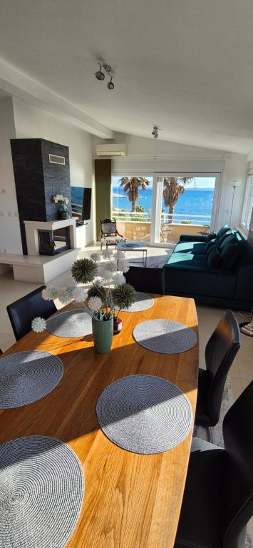 a living room with a wooden table and a couch at SkyAdria Penthouse in Vir
