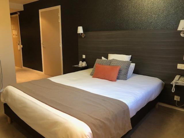Postel nebo postele na pokoji v ubytování Hôtel Arcadia