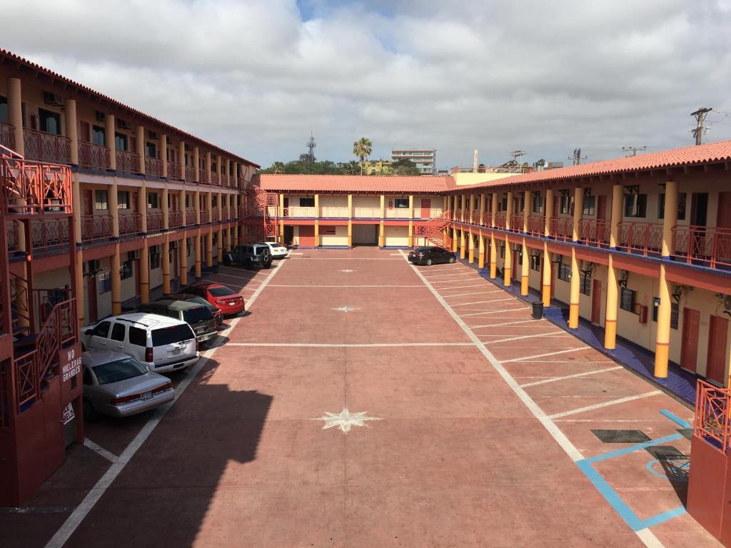 an empty parking lot in front of a building at Hotel Del Sol Inn in Rosarito
