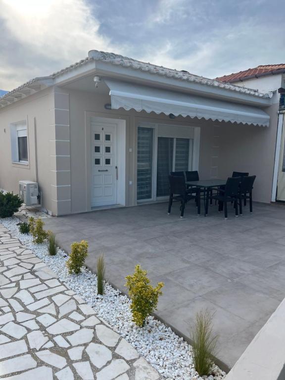 a patio with a table in front of a house at marialena villa in Skala Potamias